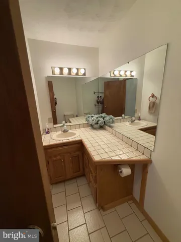 a view of a house with a patio and a yard