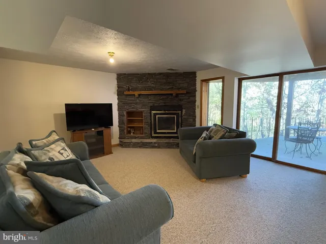 a balcony of a house with wooden floor and outdoor seating