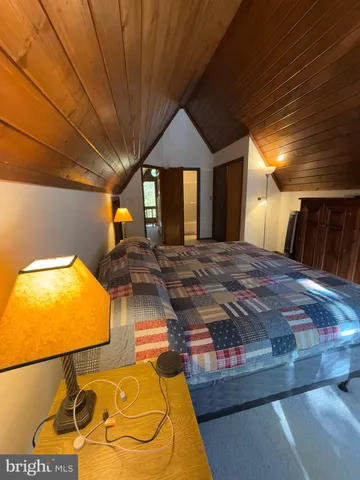 a living room with fireplace furniture and a large window