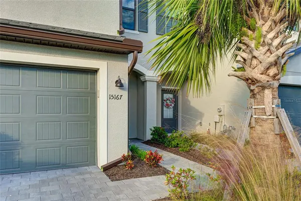 a house with a yard and potted plants