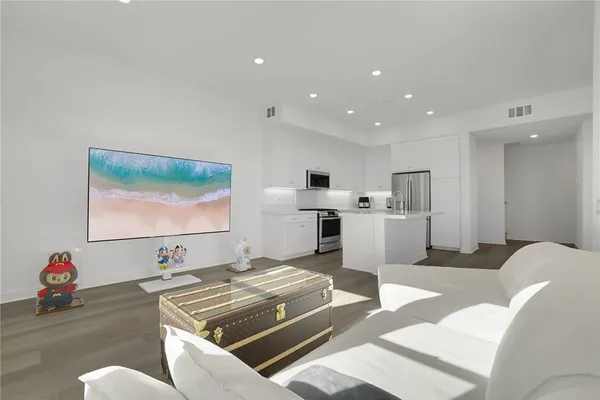 a kitchen with stainless steel appliances a refrigerator stove and sink