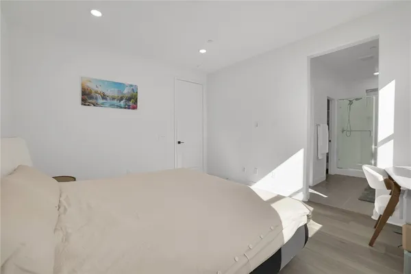 a bedroom with two beds and a window