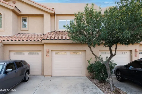 a view of garage with a car parked in front of it