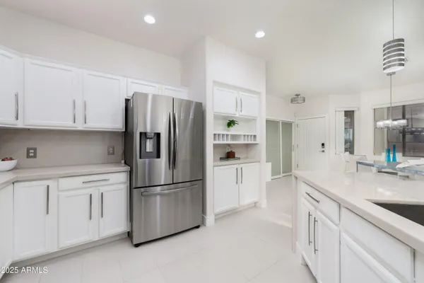 a kitchen with stainless steel appliances a refrigerator sink and cabinets