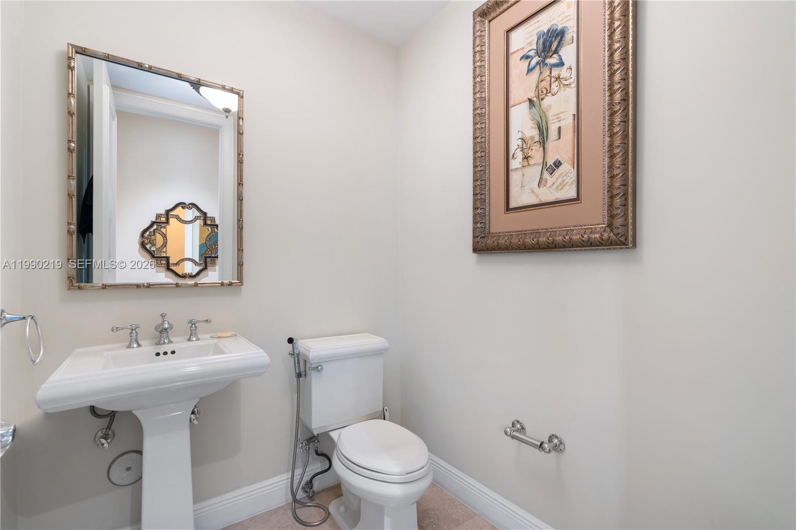 1495 Windjammer Way Hollywood, FL 33019 - Photo 14 of 48 a bathroom with a toilet sink and mirror