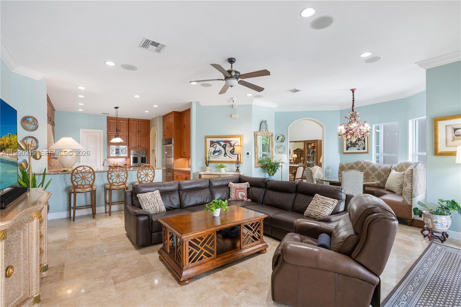 1495 Windjammer Way Hollywood, FL 33019 - Photo 15 of 48 a living room with furniture ceiling fan and a chandelier