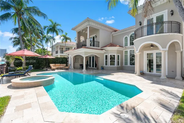 a front view of a house with swimming pool and furniture