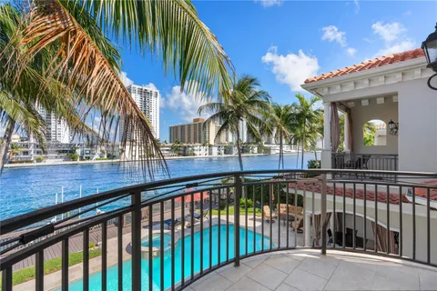 a view of a swimming pool with a lawn chair and palm trees