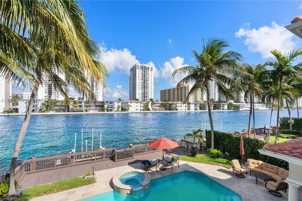 a view of a swimming pool with a patio and a garden