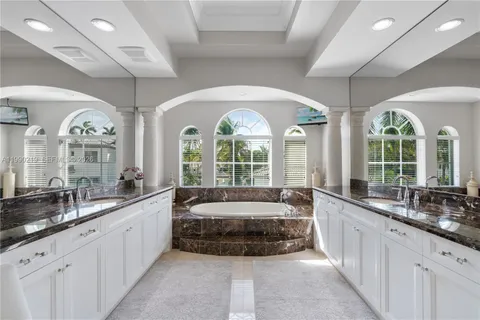 a large spacious bathroom with a large window and sink