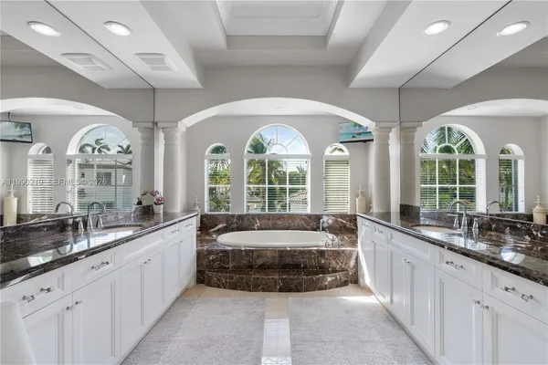 a large spacious bathroom with a large window and sink