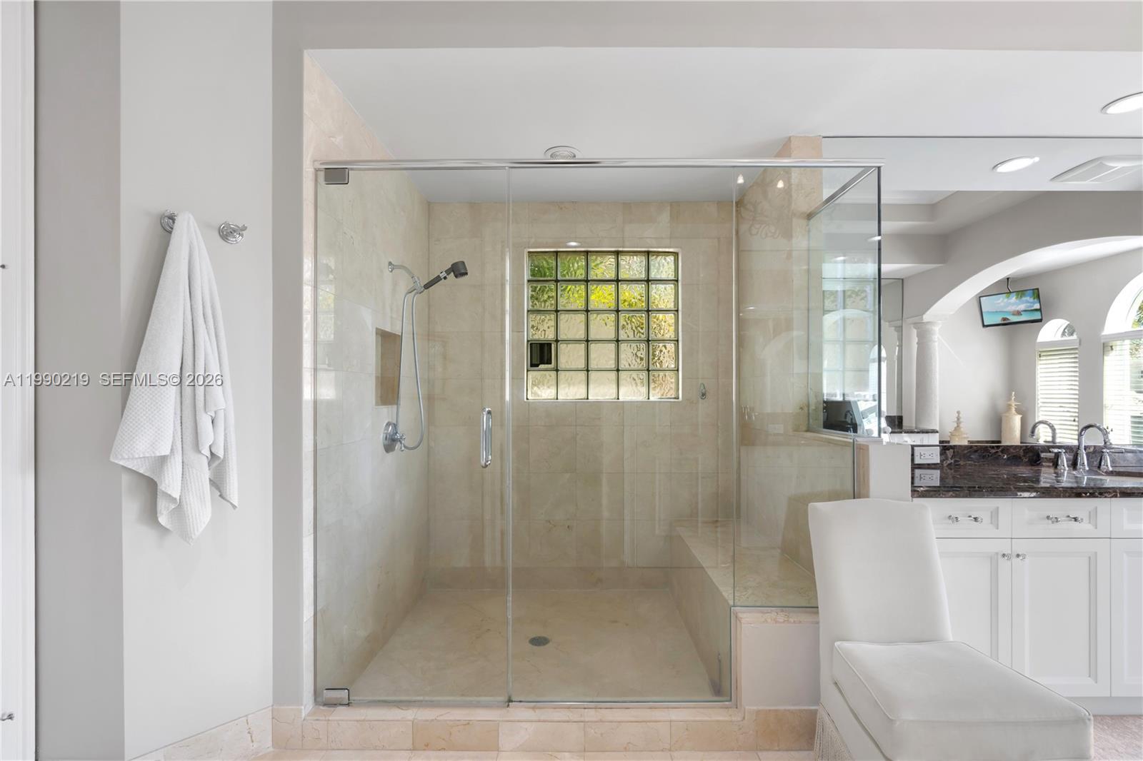 1495 Windjammer Way Hollywood, FL 33019 - Photo 29 of 48 a bathroom with a shower a mirror and a sink