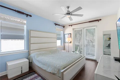 a bedroom with a large bed and a chandelier