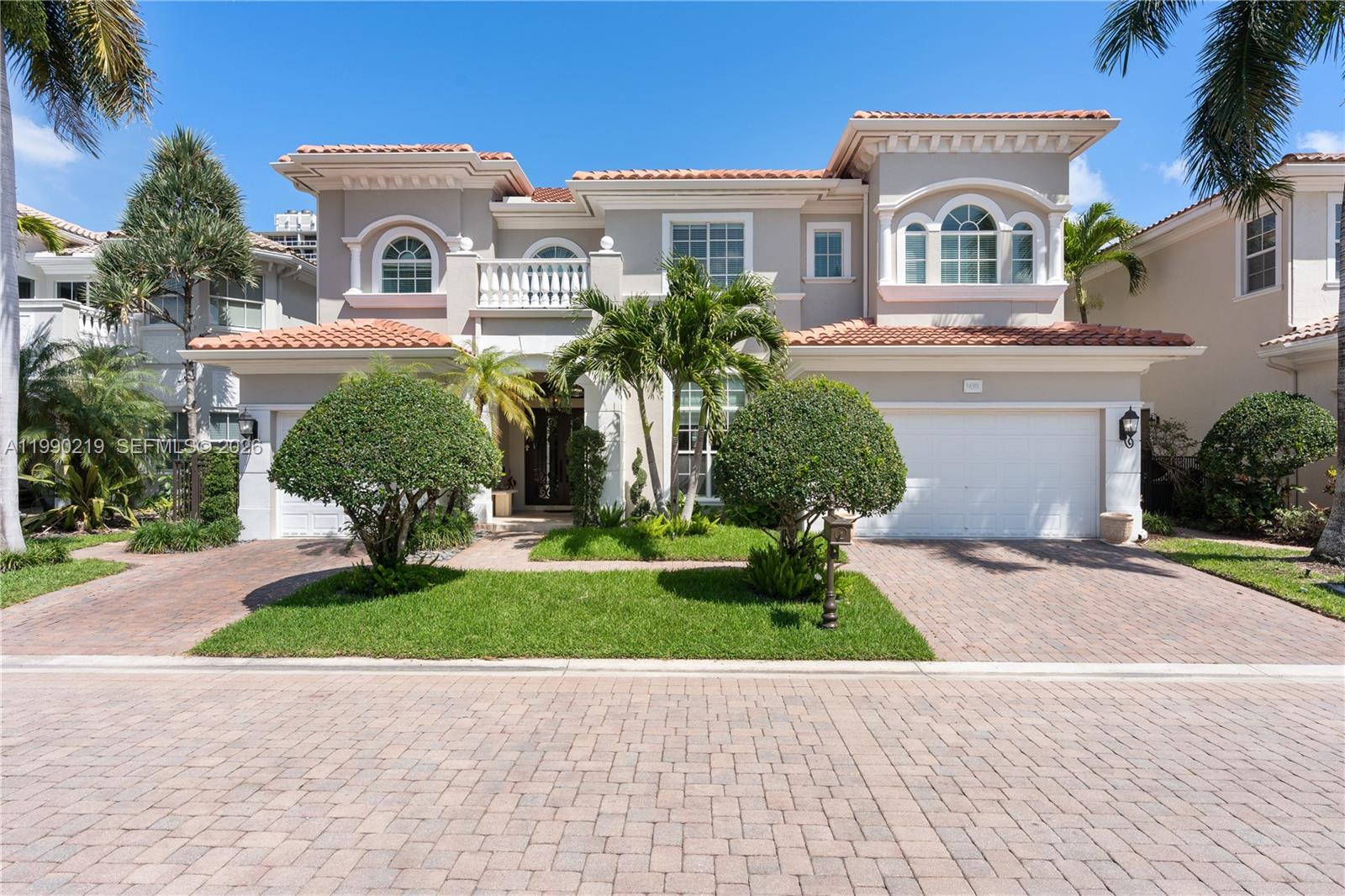1495 Windjammer Way Hollywood, FL 33019 - Photo 3 of 48 a front view of a house with a garden and trees