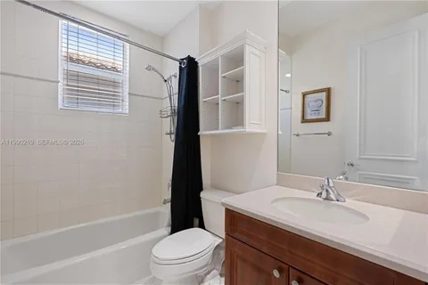 a bathroom with a granite countertop sink toilet a mirror and shower