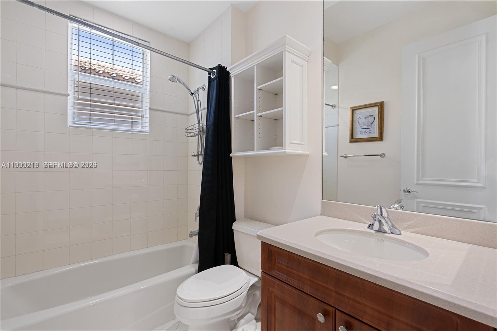 1495 Windjammer Way Hollywood, FL 33019 - Photo 34 of 48 a bathroom with a granite countertop sink toilet a mirror and shower