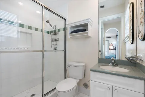 a bathroom with a granite countertop sink toilet and shower