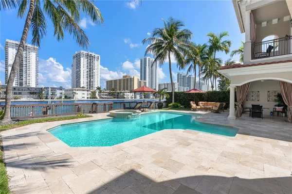 a swimming pool with outdoor seating and yard