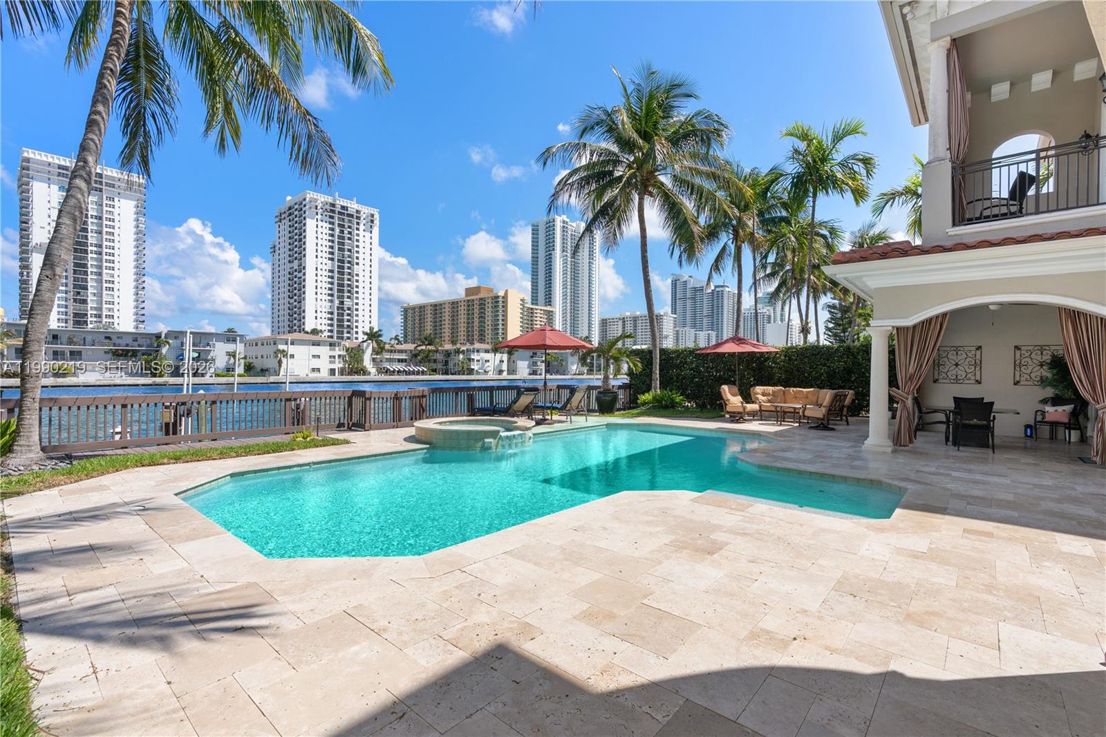 1495 Windjammer Way Hollywood, FL 33019 - Photo 37 of 48 a swimming pool with outdoor seating and yard