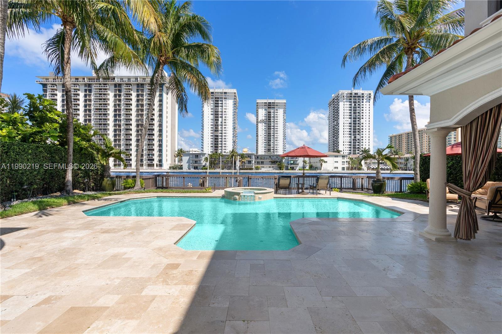 1495 Windjammer Way Hollywood, FL 33019 - Photo 38 of 48 a view of swimming pool with a table and chairs