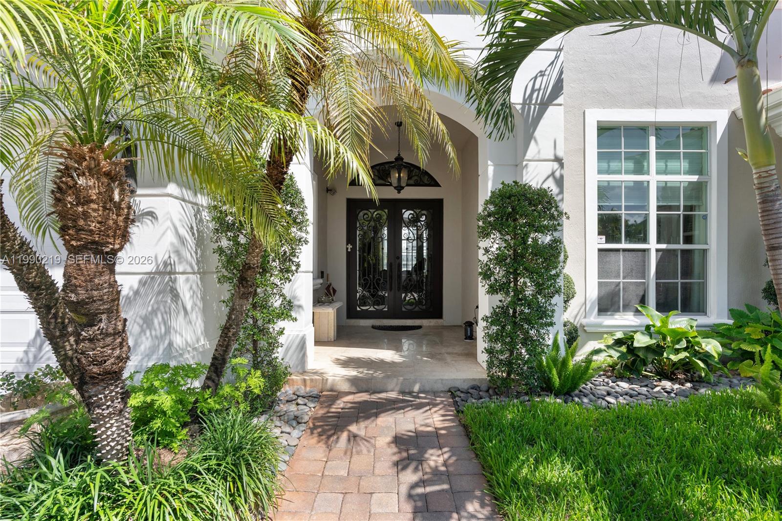 1495 Windjammer Way Hollywood, FL 33019 - Photo 4 of 48 a front view of a house with garden