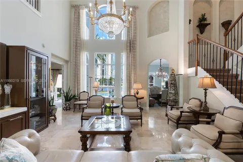 a living room with fireplace furniture and a large window
