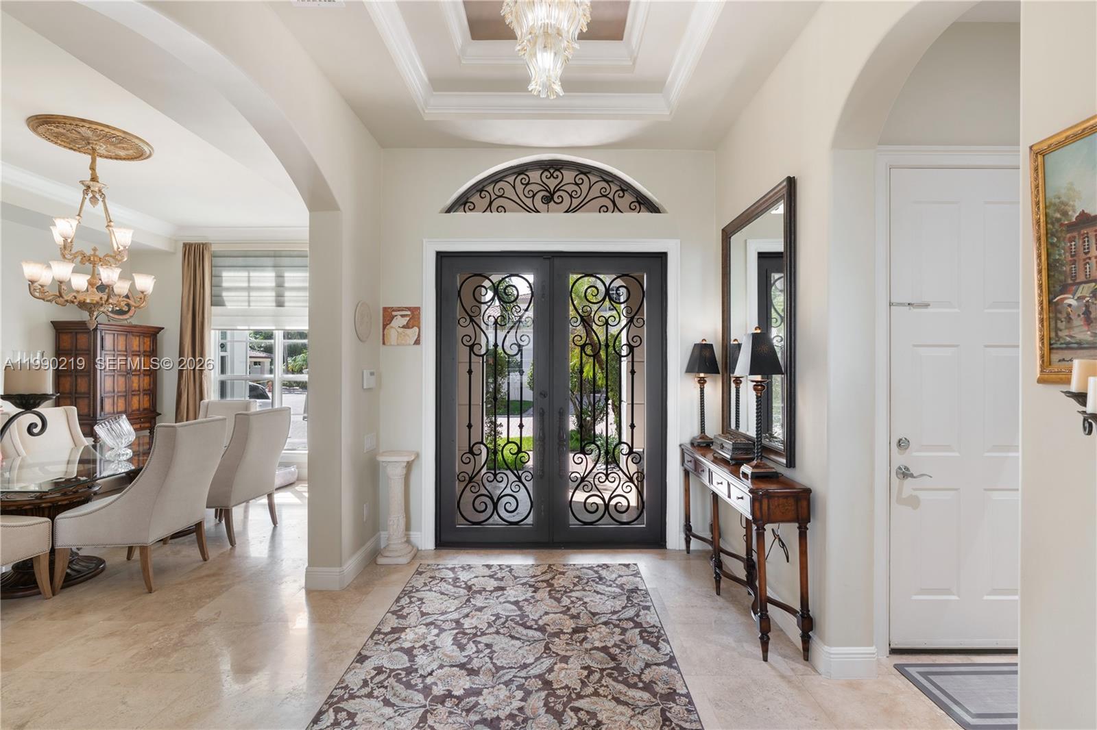 1495 Windjammer Way Hollywood, FL 33019 - Photo 9 of 48 a view of a hallway with furniture and a chandelier