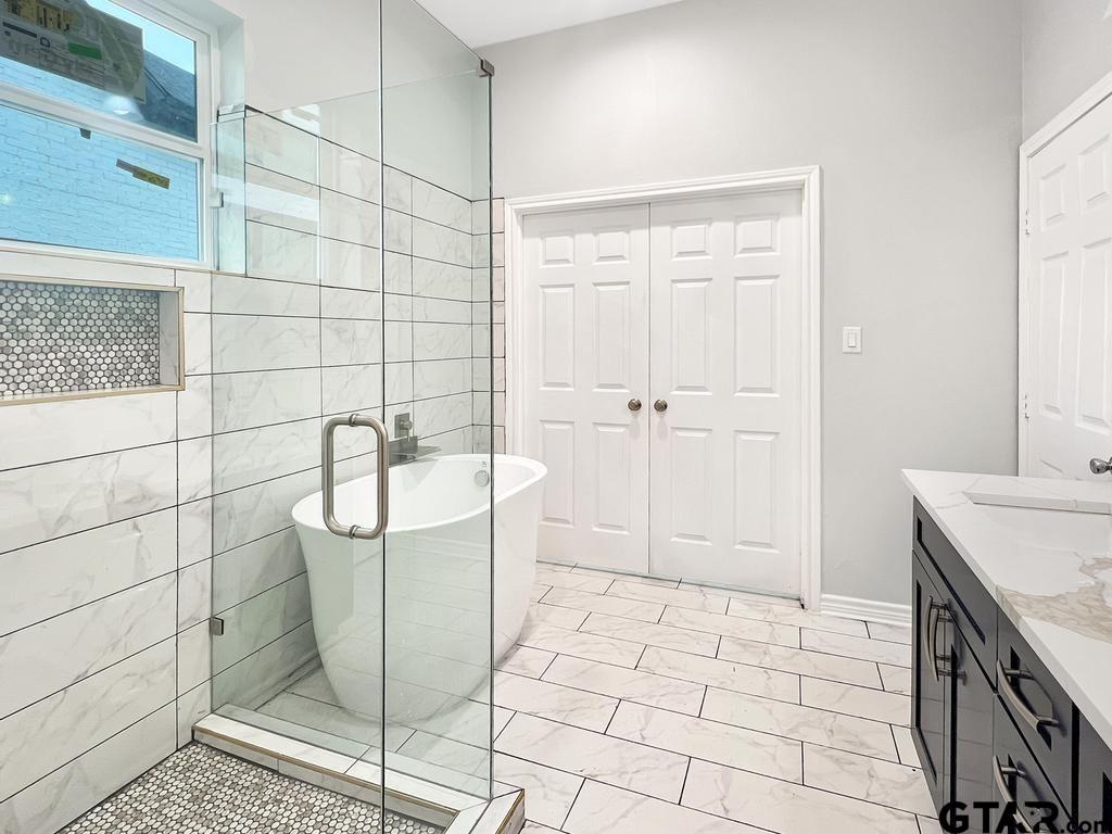 9143 Long Branch Tyler, TX 75703 - Photo 17 of 26 a bathroom with a sink a toilet and shower