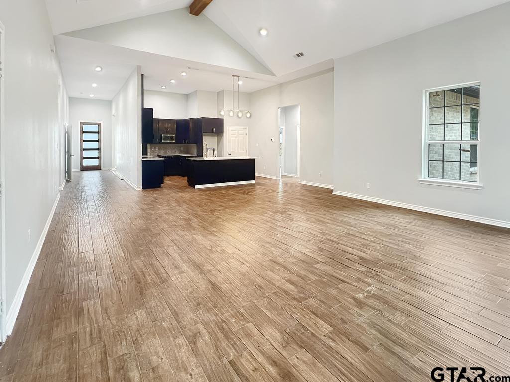 9143 Long Branch Tyler, TX 75703 - Photo 25 of 26 a view of kitchen with kitchen island granite countertop cabinets and refrigerator