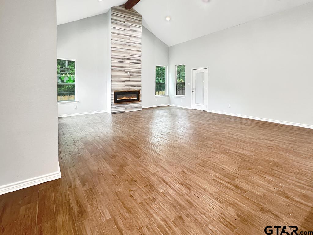9143 Long Branch Tyler, TX 75703 - Photo 10 of 26 wooden floor in an empty room with a window