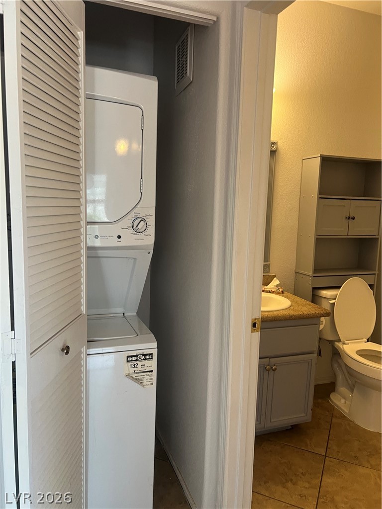3318 North Decatur Boulevard, Unit 1174 Las Vegas, NV 89130 - Photo 8 of 23 This functional laundry area includes a stacked washer and dryer, conveniently located within a practical space.