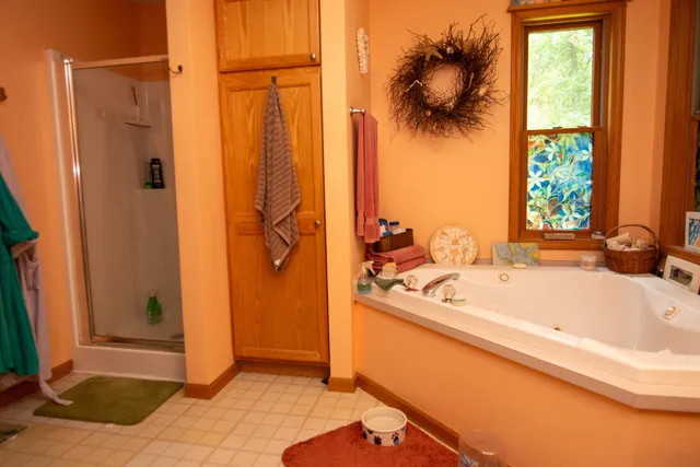 a bathroom with a tub and shower