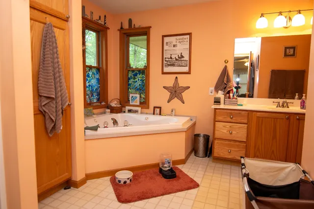 a bathroom with a sink a toilet and mirror