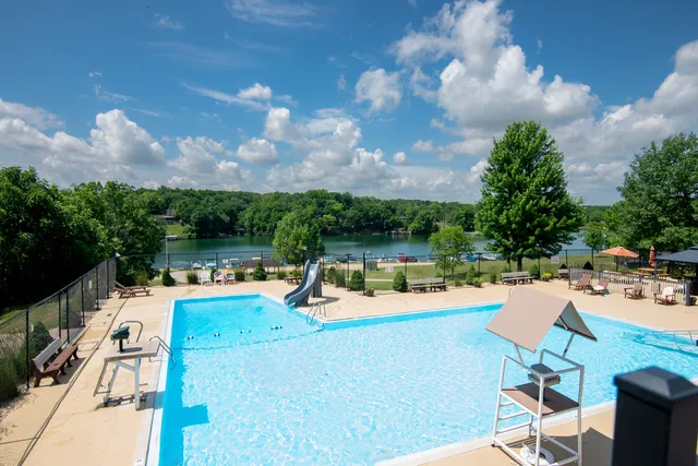 a view of a swimming pool with lounge chairs in patio