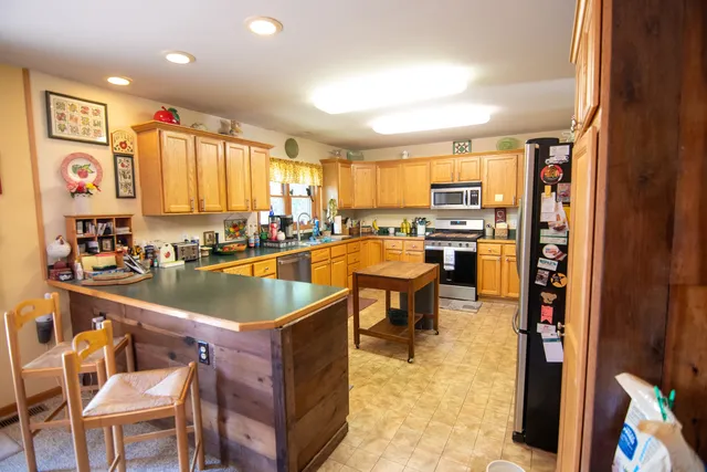 a kitchen with a sink refrigerator and cabinets