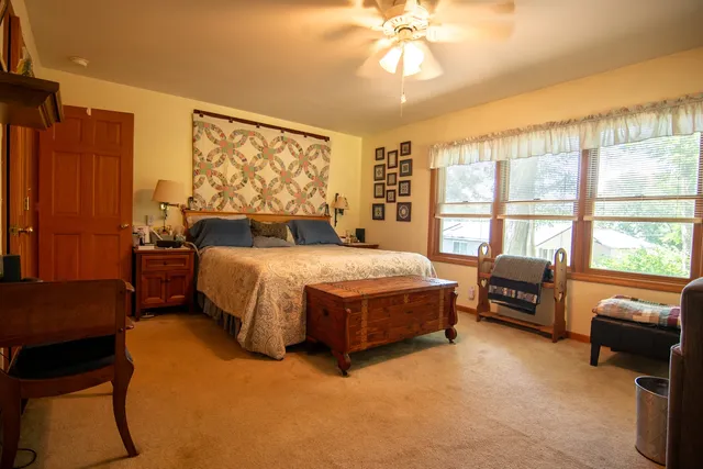 a spacious bedroom with a bed and a couch