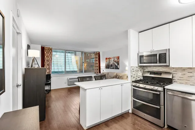 a kitchen with a sink stove and refrigerator