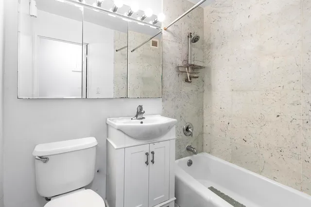 a kitchen with a refrigerator a microwave a sink and cabinets