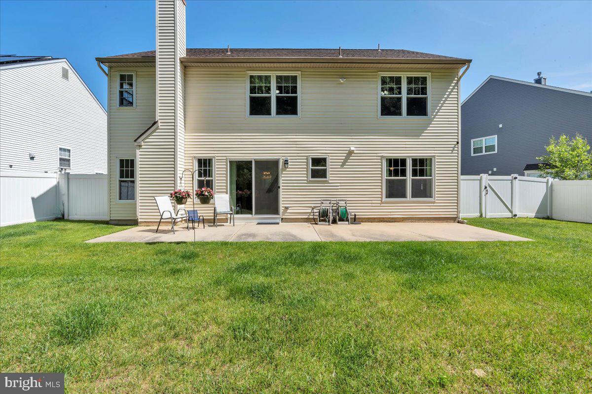 17 Vassar Road Mount Laurel, NJ 08054 - Photo 32 of 33 a view of a backyard with table and chairs potted plants and a large tree