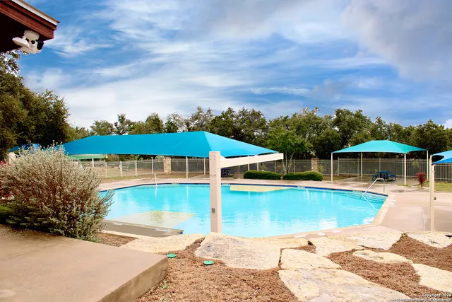 an aerial view of a house with a garden and lake view