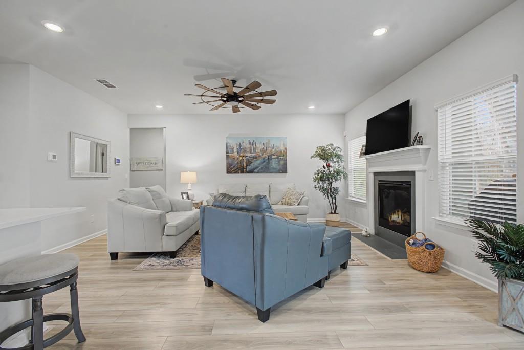 87 Cranson Walk Pendergrass, GA 30567 - Photo 16 of 50 a living room with furniture a flat screen tv and a fireplace