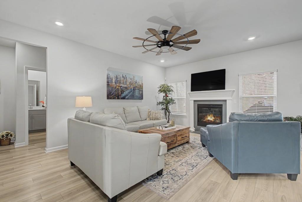 87 Cranson Walk Pendergrass, GA 30567 - Photo 20 of 50 a living room with furniture a fireplace and a flat screen tv
