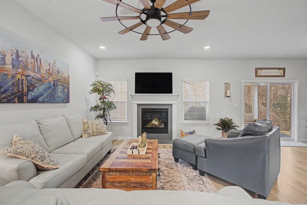 87 Cranson Walk Pendergrass, GA 30567 - Photo 21 of 50 a living room with furniture a fireplace and a flat screen tv