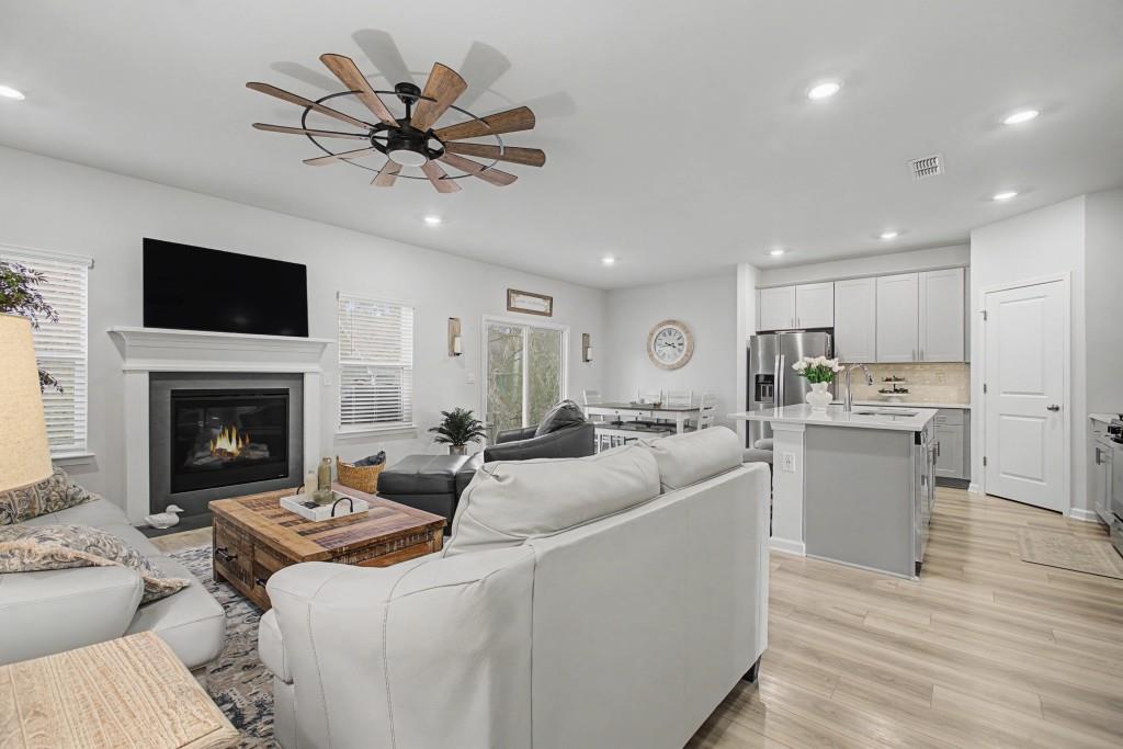 87 Cranson Walk Pendergrass, GA 30567 - Photo 22 of 50 a living room with furniture a fireplace and a flat screen tv