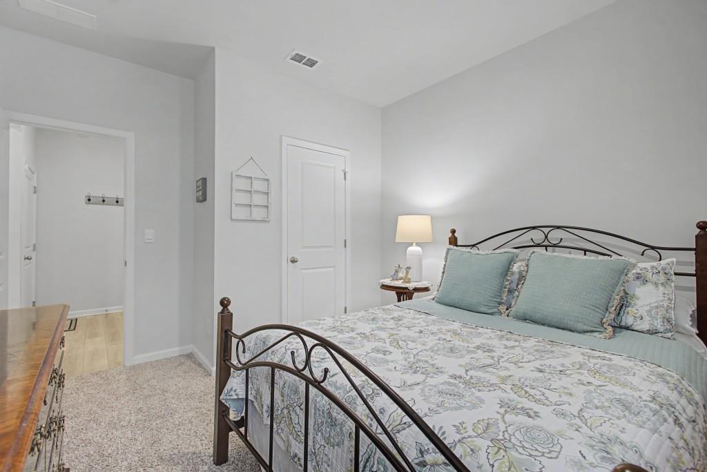87 Cranson Walk Pendergrass, GA 30567 - Photo 24 of 50 a bedroom with a bed and a mirror