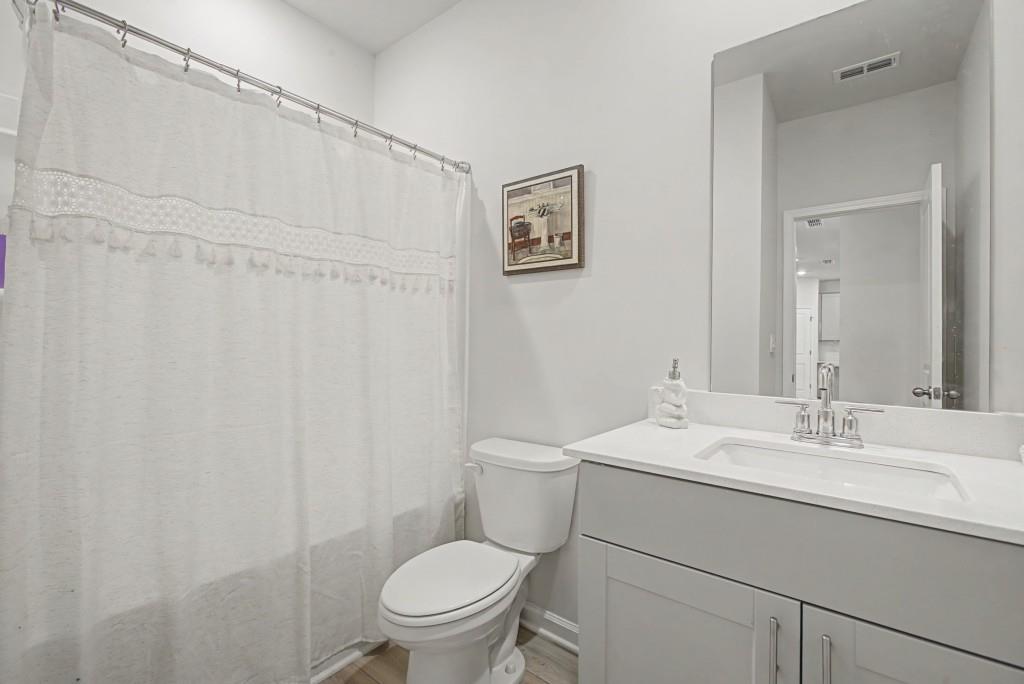 87 Cranson Walk Pendergrass, GA 30567 - Photo 25 of 50 a bathroom with a sink a toilet and a mirror