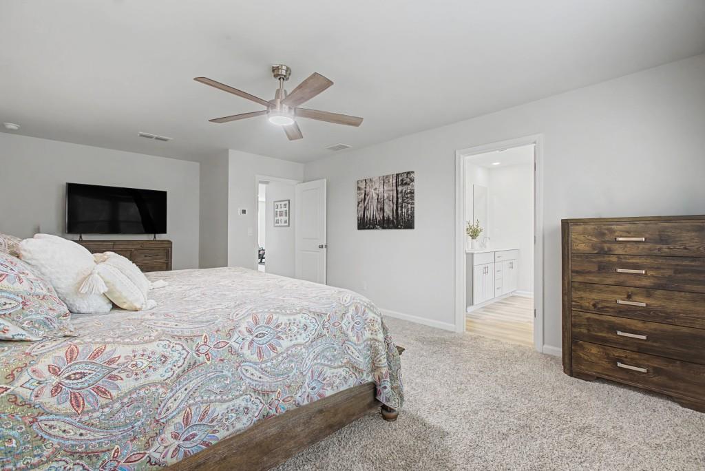 87 Cranson Walk Pendergrass, GA 30567 - Photo 28 of 50 a bedroom with a bed and a tv
