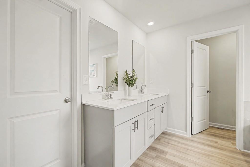 87 Cranson Walk Pendergrass, GA 30567 - Photo 30 of 50 a bathroom with a double vanity sink and mirror