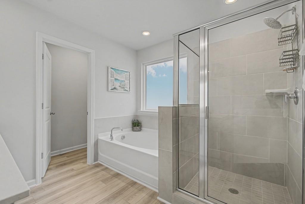 87 Cranson Walk Pendergrass, GA 30567 - Photo 31 of 50 a bathroom with a bathtub and a shower