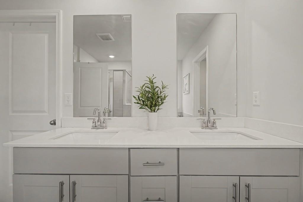 87 Cranson Walk Pendergrass, GA 30567 - Photo 33 of 50 a bathroom with double vanity sinks and a mirror